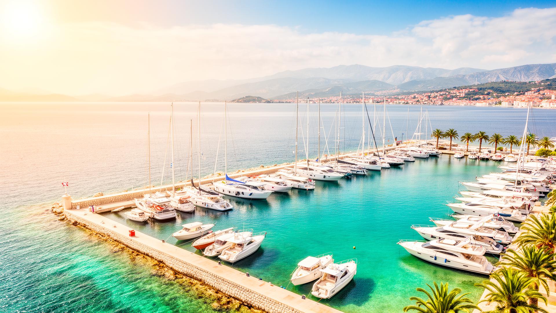 Sunny Dalmatian marina with white yachts and turquoise Adriatic sea